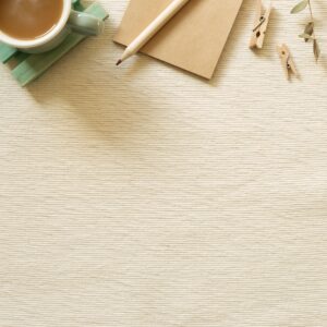 Weekly planner with coffee and stationery in a soft neutral flat lay