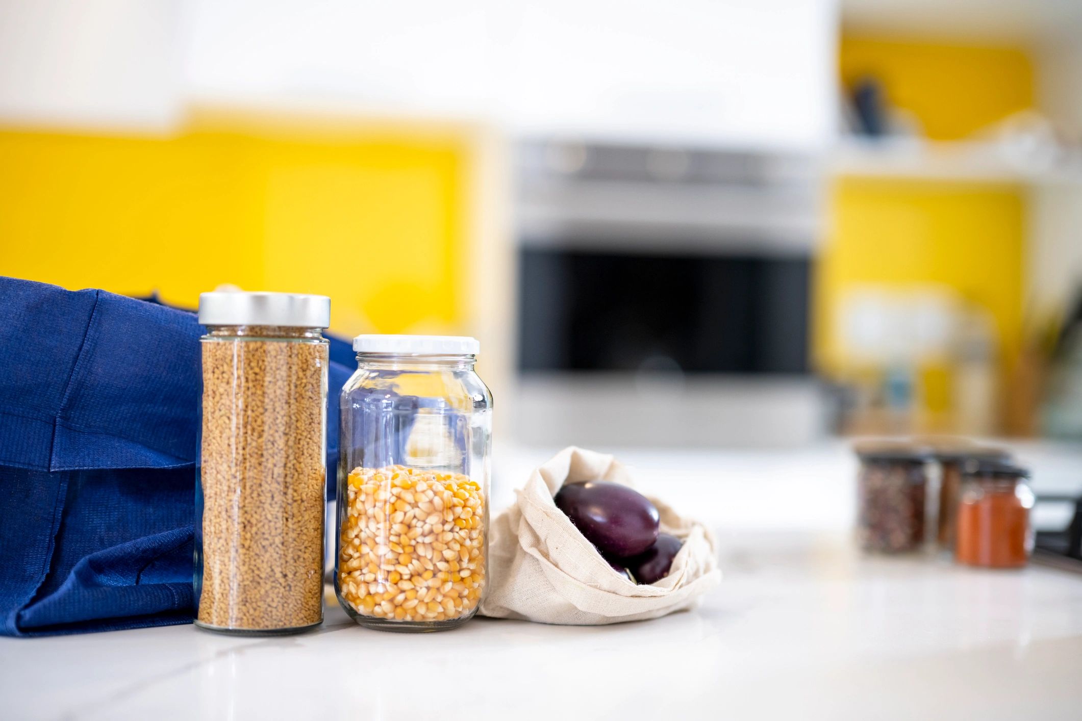 Organized pantry with reusable glass jars and produce bags