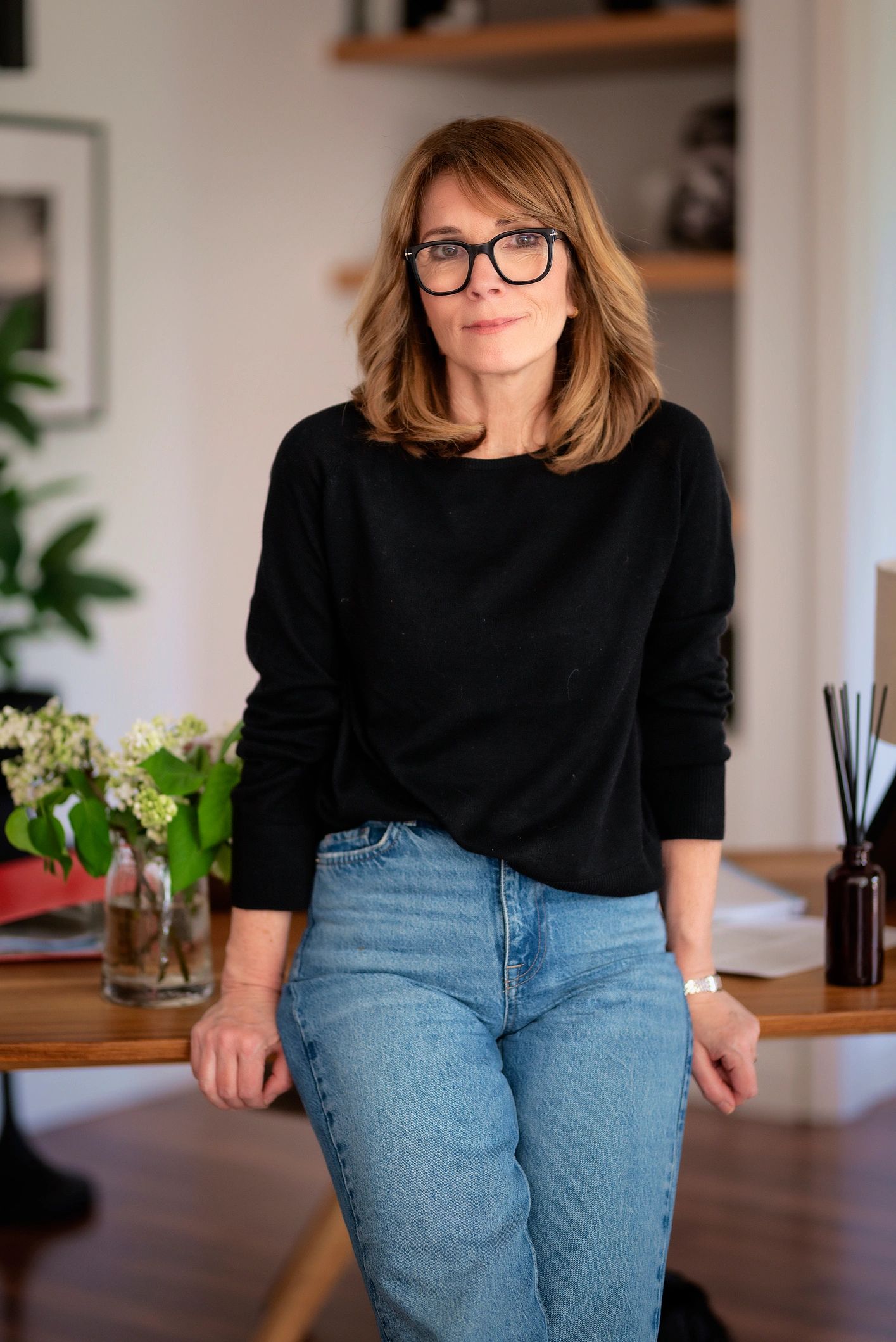 Woman standing in a warm, modern home workspace