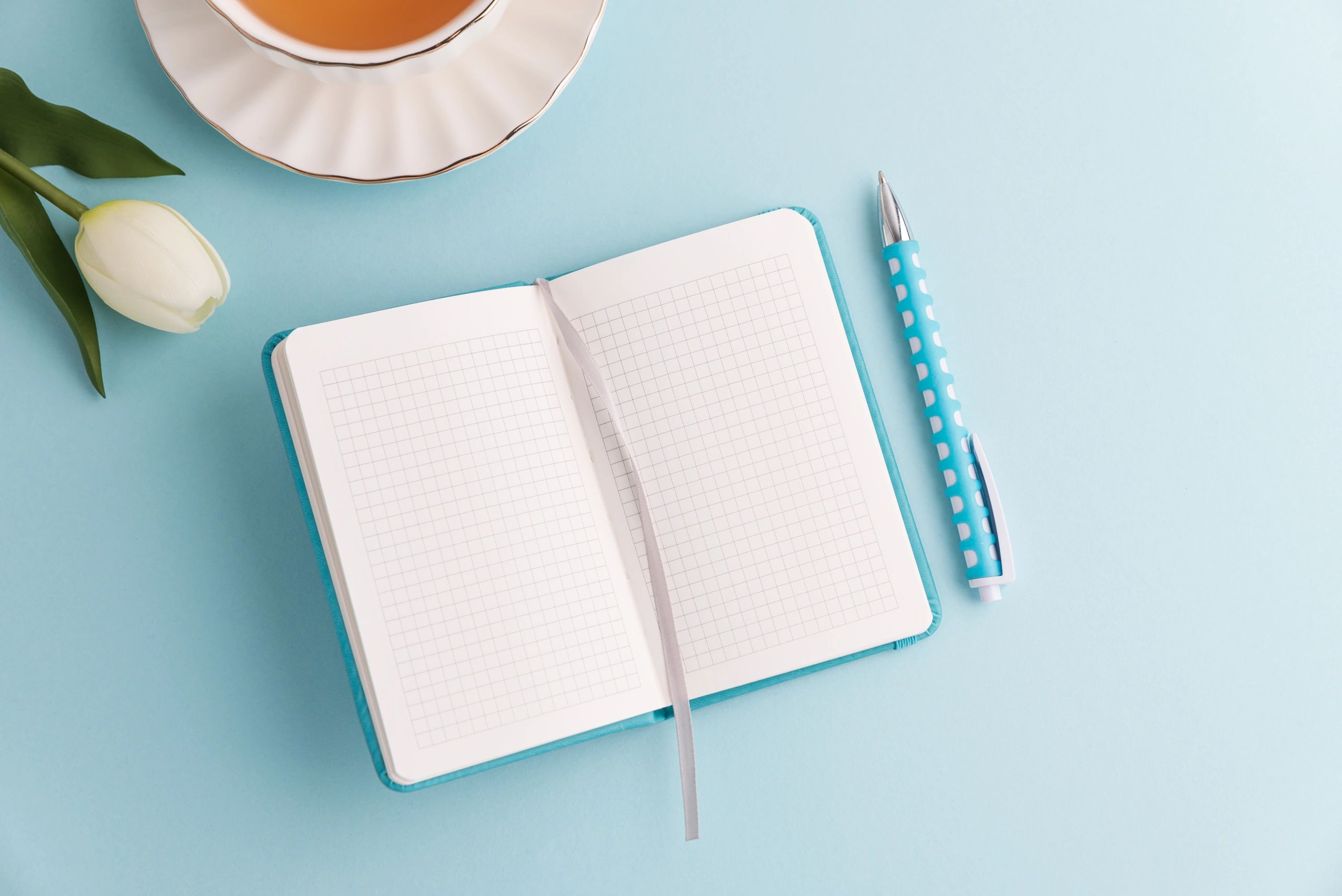 Calm and organized flat lay composition with tea and tulips